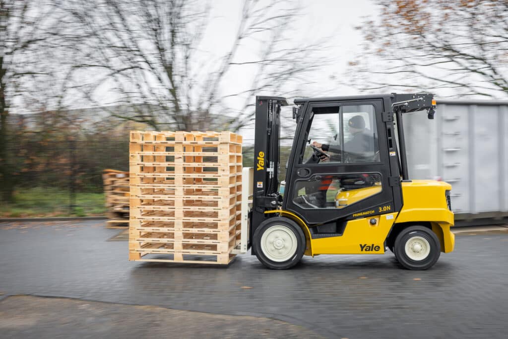 Yellow Yale Forklift moving pallets
