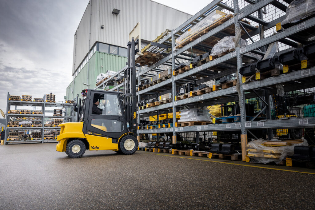 Yale forklift in outdoor storage, safely lifting a pallet down from outdoor racking.